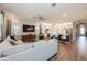 Cozy living room open to kitchen featuring natural light, modern furniture, and open floor plan at 1757 Standing Rock Cir, Oakland, FL 34787