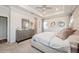 Comfortable main bedroom featuring a decorative mirror and neutral wall art at 1757 Standing Rock Cir, Oakland, FL 34787
