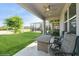 Covered patio with ceiling fan, outdoor furniture, and beautiful landscaping at 1757 Standing Rock Cir, Oakland, FL 34787