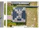 Aerial view of roof with solar panels, brick driveway, manicured lawn and neighborhood at 178 Aria Way, Davenport, FL 33837