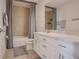 Bathroom featuring a white vanity with drawers, tub with shower and gray curtain, and a framed mirror at 178 Aria Way, Davenport, FL 33837