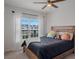 Cozy bedroom with a large window, comfortable bed, and plush pillows with natural light at 178 Aria Way, Davenport, FL 33837