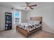 Well-lit bedroom featuring a wood-framed bed, a window with blinds, and a dark bookshelf at 178 Aria Way, Davenport, FL 33837