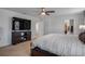 Spacious bedroom with a ceiling fan, a TV atop a wooden media console, and a walk-in closet at 178 Aria Way, Davenport, FL 33837
