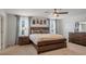 Comfortable bedroom with a wooden bed frame, bedside tables with lamps, and framed artwork above the bed at 178 Aria Way, Davenport, FL 33837