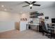 Bright bedroom featuring a modern ceiling fan, a workspace, and a small staircase on the side at 178 Aria Way, Davenport, FL 33837