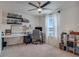 Bright bedroom featuring a modern ceiling fan, a workspace, and open shelving for stylish organization at 178 Aria Way, Davenport, FL 33837
