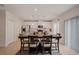 Dining area featuring a table with seating for six, complemented by a view into the kitchen at 178 Aria Way, Davenport, FL 33837