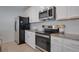 Well-equipped kitchen with stainless steel appliances, granite countertops, and ample cabinet space at 178 Aria Way, Davenport, FL 33837