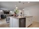 Kitchen island with granite countertops, stainless steel dishwasher, and open view to the adjacent living area at 178 Aria Way, Davenport, FL 33837