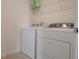 Bright laundry room featuring a modern washer and dryer, complemented by a wire shelf above for storage at 178 Aria Way, Davenport, FL 33837