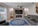 Bright living area with stone fireplace, large windows, and comfortable seating creating an inviting space at 178 Aria Way, Davenport, FL 33837