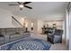 Spacious living room with modern furniture, open to dining area and kitchen, perfect for entertaining at 178 Aria Way, Davenport, FL 33837
