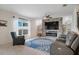 Living room boasts a stone fireplace, large window, plush seating, and a stylish blue rug at 178 Aria Way, Davenport, FL 33837