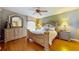 Well-lit bedroom with a beautiful mirror, hardwood floors, and decorative lamps at 21 Abbey Ct, Haines City, FL 33844