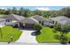 Charming home with a well-manicured lawn, paved driveway, and beautiful landscaping at 21 Abbey Ct, Haines City, FL 33844