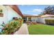 Inviting walkway to front door with lush landscaping and a decorative water feature in the front yard at 21 Abbey Ct, Haines City, FL 33844