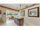 Open kitchen with large island flowing into sunroom and a view of the backyard at 21 Abbey Ct, Haines City, FL 33844