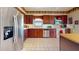 Bright kitchen featuring wood cabinetry, stainless steel appliances, and tile flooring at 21 Abbey Ct, Haines City, FL 33844