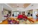 Open-concept living area with hardwood floors and views to the entry, bar, and dining areas at 21 Abbey Ct, Haines City, FL 33844