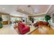 Spacious living room featuring hardwood flooring, neutral walls, and a seamless flow to the dining room at 21 Abbey Ct, Haines City, FL 33844