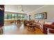 Inviting living room with ample seating, large windows, wood floors, and a ceiling fan at 21 Abbey Ct, Haines City, FL 33844