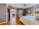 Spacious main bedroom with ceiling fan, light wood floors and dresser, plus ensuite access at 21 Abbey Ct, Haines City, FL 33844