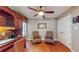 Well-lit office area with built-in shelving, wood floors, and two armchairs at 21 Abbey Ct, Haines City, FL 33844
