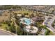 An aerial view of the community features a pool, splash pad, sports field, and walking paths, surrounded by homes at 2126 Ridge Pointe Ln, Clermont, FL 34715