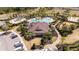 Aerial view of the community clubhouse and pool with lush landscaping at 2126 Ridge Pointe Ln, Clermont, FL 34715