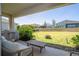 A great outdoor patio with seating with a view of a large, fully fenced backyard at 2126 Ridge Pointe Ln, Clermont, FL 34715