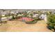 The basketball court is fenced-in and features vibrant red and blue colors, and is nestled within palm trees and landscaping at 2126 Ridge Pointe Ln, Clermont, FL 34715