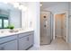 Modern bathroom featuring double vanity, glass shower, and neutral finishes at 2126 Ridge Pointe Ln, Clermont, FL 34715
