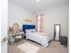 Cozy bedroom with blue bed, mirrored vanity and soft area rug at 2126 Ridge Pointe Ln, Clermont, FL 34715
