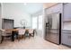 Bright dining area with light wood table, neutral chairs, and stainless steel refrigerator at 2126 Ridge Pointe Ln, Clermont, FL 34715