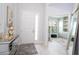 Bright foyer with white front door, transom window, wood-look tile floors, and elegant decor at 2126 Ridge Pointe Ln, Clermont, FL 34715