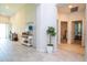 Hallway featuring wood-look tile, console table, and access to bedrooms, creating an inviting path at 2126 Ridge Pointe Ln, Clermont, FL 34715