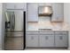 Close up of kitchen with stainless steel fridge and gray cabinets at 2126 Ridge Pointe Ln, Clermont, FL 34715