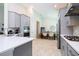 Open-concept kitchen with gray cabinets, stainless steel appliances, and an adjacent dining area at 2126 Ridge Pointe Ln, Clermont, FL 34715