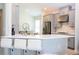 Modern kitchen featuring gray cabinetry, stainless steel appliances, breakfast bar, and white countertops at 2126 Ridge Pointe Ln, Clermont, FL 34715