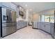 Bright, modern kitchen featuring stainless steel appliances and gray cabinetry at 2126 Ridge Pointe Ln, Clermont, FL 34715