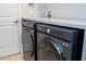 Close up of the laundry room featuring front load washer/dryer units at 2126 Ridge Pointe Ln, Clermont, FL 34715