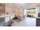 Open concept living room with barstool seating and sliding glass doors to the backyard at 2126 Ridge Pointe Ln, Clermont, FL 34715