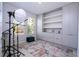 Home office featuring custom built-in shelving and storage cabinets and a cozy blue ottoman at 2126 Ridge Pointe Ln, Clermont, FL 34715