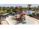 This splash pad features an interactive play structure, lounge chairs, and umbrellas, near the resort-style pool at 2126 Ridge Pointe Ln, Clermont, FL 34715