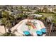 The splash pad features a multi-tiered play structure, surrounded by lounge chairs, umbrellas, and lush palm trees at 2126 Ridge Pointe Ln, Clermont, FL 34715