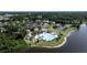 Aerial view of a community pool, tennis courts, lakes and clubhouse nestled within lush landscaping at 220 Wimbledon Cir, Lake Mary, FL 32746