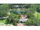 Aerial view of the community entrance, with its water feature, landscaping, and well-kept grounds at 220 Wimbledon Cir, Lake Mary, FL 32746