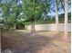 Spacious backyard with mature trees and privacy wall at 220 Wimbledon Cir, Lake Mary, FL 32746