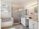 Bathroom featuring a luxurious soaking tub, tiled walk-in shower, and double sink vanity at 220 Wimbledon Cir, Lake Mary, FL 32746